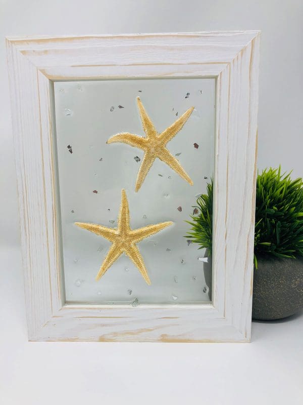 starfish resin wall art with white frame standing upright