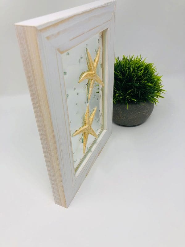 starfish resin wall art with white frame diagonal view
